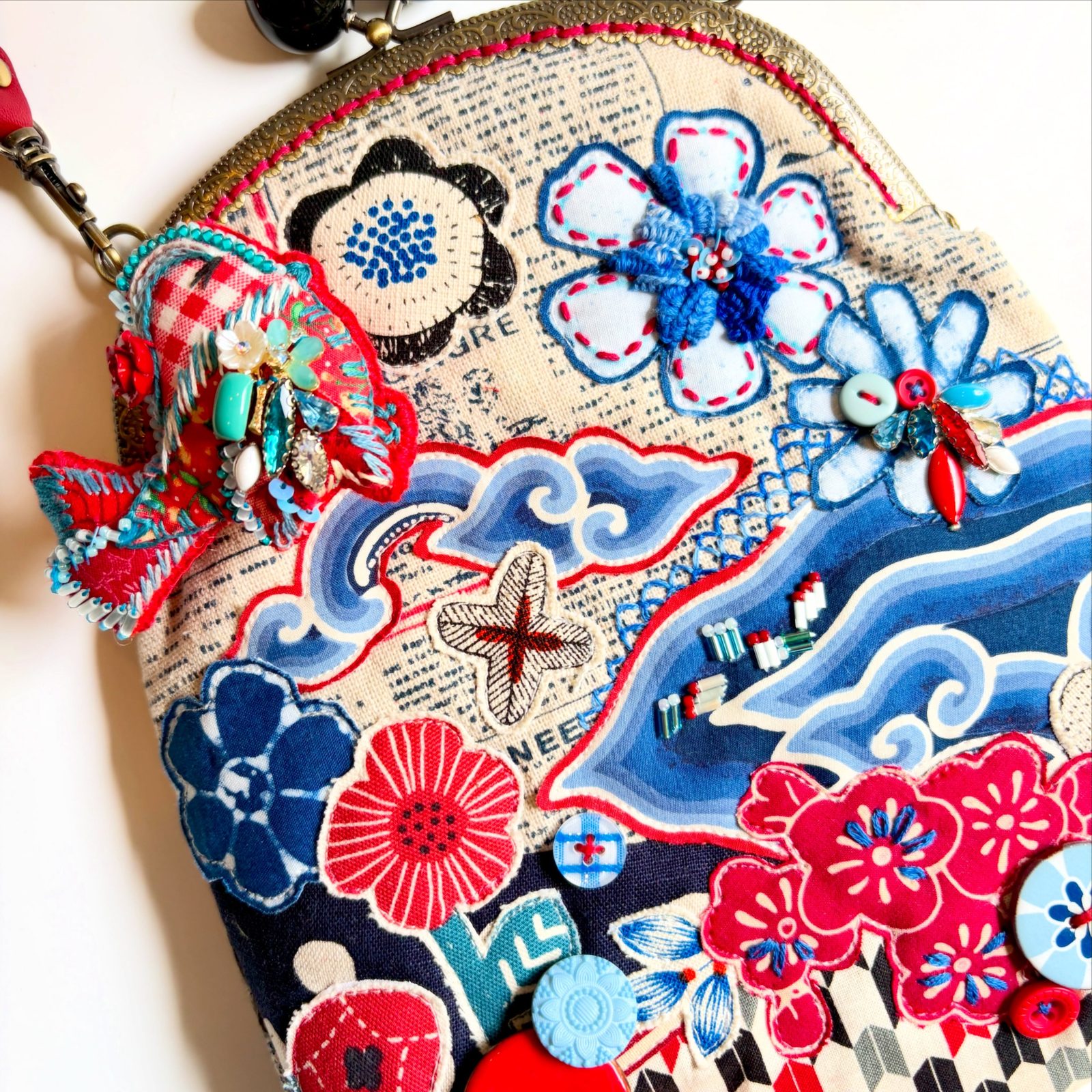 Close-up of a batik floral kiss-lock bag with a red tassel